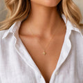 Gold plated guiding star necklace in minimalist style with dainty chain included modelled on fair hair female