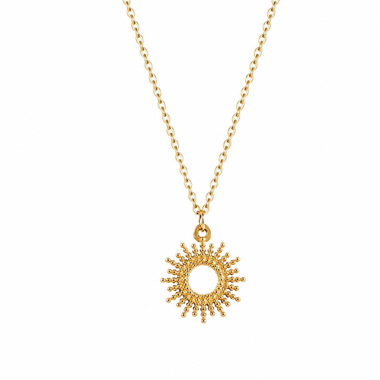 Gold plated necklace featuring a delicate chain and a circular pendant with a sunburst design. The pendant has a central open circle surrounded by small, radiating beaded spikes, creating a textured, metallic sun-like appearance.