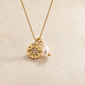 guiding star necklace with faux pearl suspended on chain on neutral background